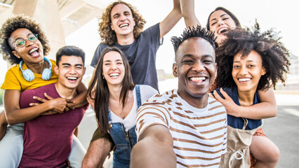Group multiracial friends taking selfie picture with mobile smartphone outside - Happy young with...