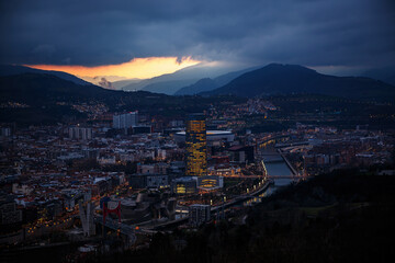 Dusk, twilight over Bilbao city in Basque Country, Spain. Town between mountains.