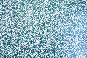 Fragment of a ceramic floor with green stones. texture background. texture with colorful spots, for add text or work design for backdrop product. top view