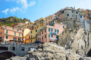 Fototapeta na wymiar The colorful hillside homes and shops in the picturesque village of Manarola, Italy, one of the five Cinque Terre villages along the sea.