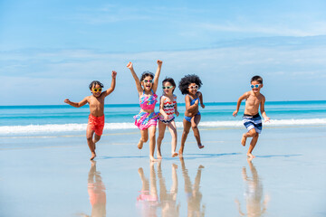 Group of Diversity little child boy and girl friends running and playing in sea water on tropical beach together on summer vacation. Happy children kid enjoy and fun outdoor lifestyle on beach holiday - Powered by Adobe