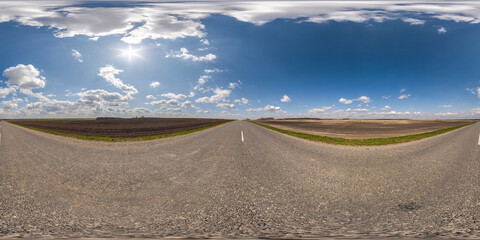full seamless spherical hdri 360 panorama view on no traffic asphalt road among fields in summer day with clear sky and awesome clouds in equirectangular projection, ready for VR AR virtual reality
