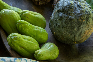 Kabocha pumpkin with chayote on wooden bowl