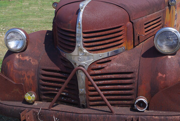 Old rusty truck - partial front view emphasizing grille
