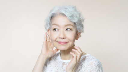 グレイヘアをお手入れするシニア女性