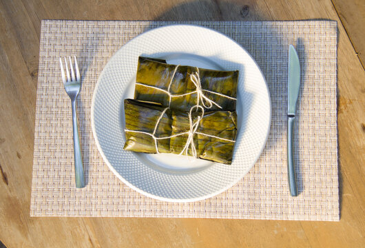 Dominican Pasteles en Hoja is a plantain and tuber dough filled with meat wrapped in plantain leaves. It is similar to Mexican tamales
