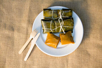 Dominican Pasteles en Hoja is a plantain and tuber dough filled with meat wrapped in plantain leaves. It is similar to Mexican tamales © Carlos Nin Gómez
