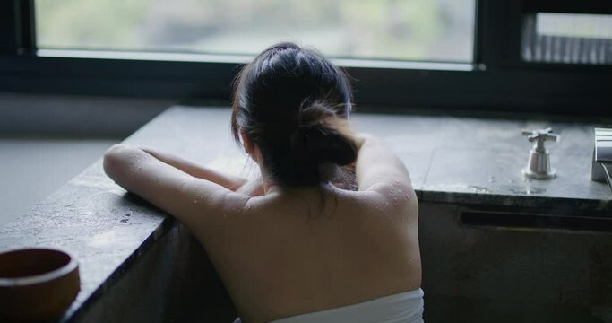 Woman enjoy her hot spring at winter time