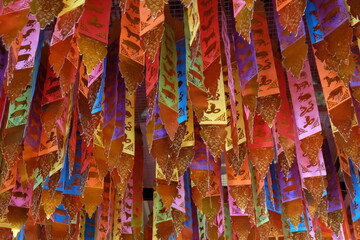 colorful scarves with traditional Buddhist symbols at the Buddhist temple in Chiang Mai, Thailand
