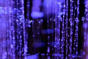 fiber optic’s purple  background with lots lights spots and glass lines. Blurred  focus 