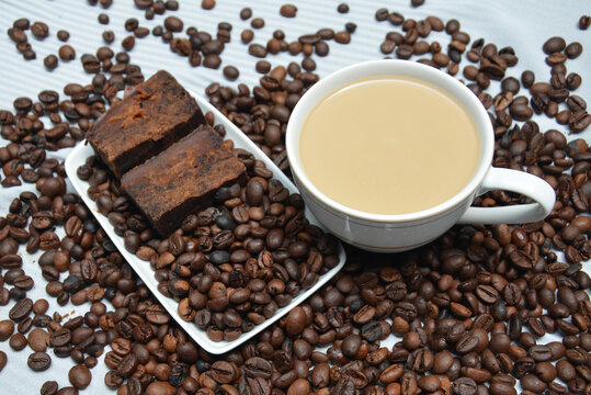 Cup of coffee latte and coffee beans with natural background