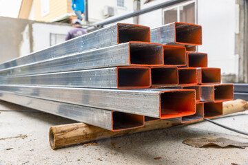 Galvanized rectangular steel tube in construction site. - obrazy, fototapety, plakaty