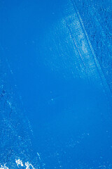 deep blue abstract background, applied toning primer on a white surface