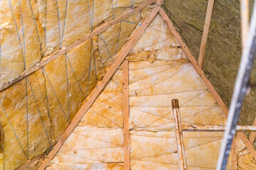 The roof is insulated with the first layer of yellow glass wool