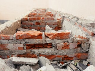 Close-up of the rubble of an industrial building collapsing into a pile of concrete and brick. and...