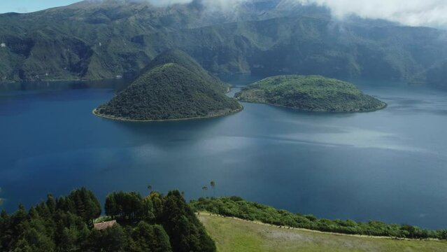 Laguna Cuicocha, Ecuador: Aerial drone footage with tilt up motion of the Laguna Cuicocha at the foot of the Cotacachi volcano near Otavalo in the Andes mountains in Ecuador in south America 