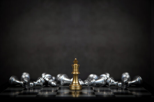 Close up king chess stand with falling chess on the back concept of team player or business team and leadership strategy and human resources organization management.