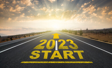 Start plan for 2023. The year 2023 was written on the asphalt road at sunrise. Concept of business...