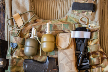Military reinforced bulletproof vest and pistol, weapon, uniform of a Ukrainian soldier in the war, army of Ukraine