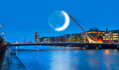 Samuel Backett Bridge (Harp Bridge) at twilight blue hour with crescent - River Liffey, Dublin ...