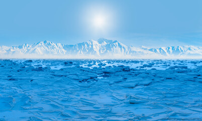 Beautiful winter landscape of frozen lake at sunrise - Snowy ice hummocks with transparent blue...