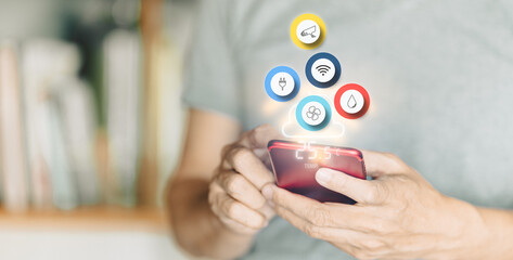 A man controls smart home automation with his smartphone