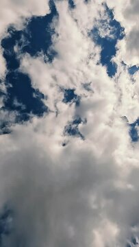 Time lapse footage of a deep blue sky with fluffy white clouds.
