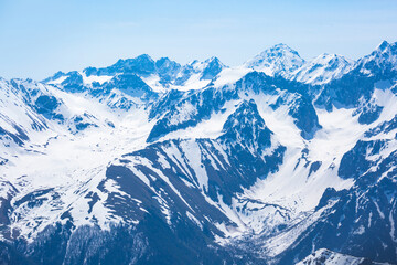 Fototapeta na wymiar Snow-capped peaks of the Caucasus Mountains landscape. Karachay-Cherkessia, Russia