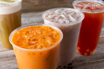 A view of some cold fruit tea and milk tea beverages.
