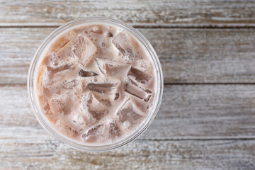 A top down view of an iced milk tea beverage.