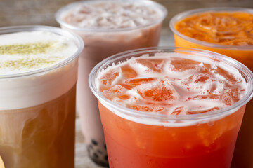 A view of some cold fruit tea and milk tea beverages.