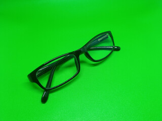 green background black frame glasses