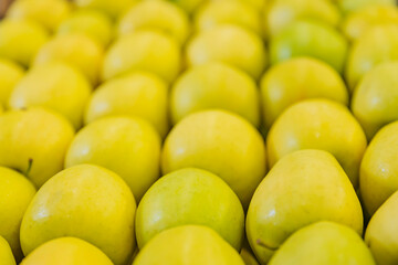 yellow apples packed in cardboard boxes close-up
