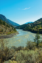 Fototapeta na wymiar The Fraser River flows through the rugged landscape north of Lillooet, British Columbia, Canada