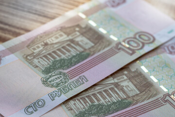 Fototapeta na wymiar Russian banknotes of one hundred rubles are on the table