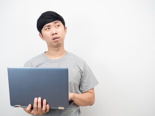 Man using laptop feeling tried and bored looking at copy space
