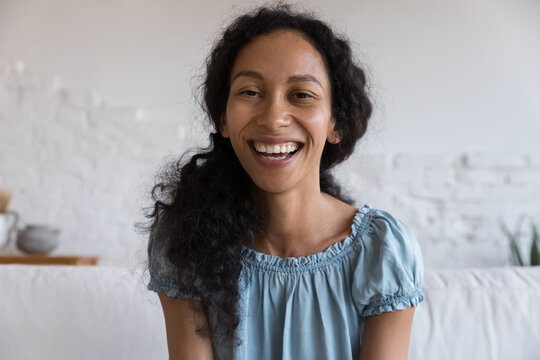 Happy cheerful African American blogger woman with toothy smile talking on video call, looking at camera, smiling, laughing, giving online workshop. Freelance employee, student head shot portrait