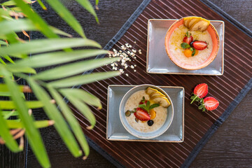 Healthy breakfast in a bowl with homemade baked granola, fresh strawberries
