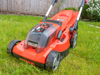 Obraz premium front of Cordless battery operated Lawn Mower with height adjustable blade