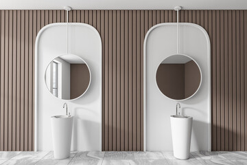 Light bathroom interior with sink and mirror, tile floor