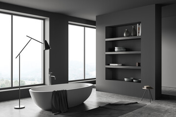 Fototapeta na wymiar Grey bathroom interior with tub, shelf with decoration and panoramic window