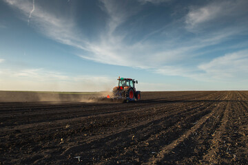 Fototapeta premium Tractor working in the field