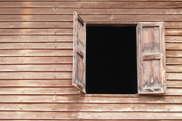 Wooden windows and walls of a wooden house of an old house.