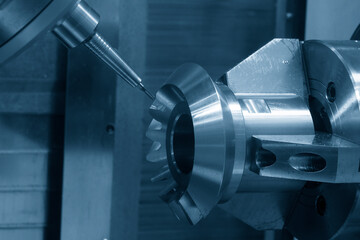 The 5-axis CNC milling machine  cutting the metal gear part.
