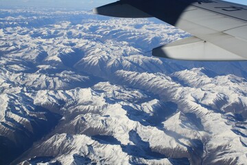aerial view from window.landscape from china eastern airline window above snow mountains range  in china ( Tibet  to XI AN)