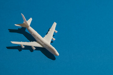 A miniature airplane isolated on blue background, Travel or traffic background, Nobody	