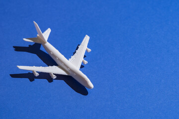 A miniature airplane isolated on blue background, Travel or traffic background, Nobody