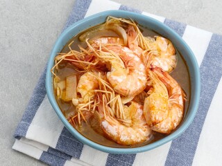 Udang Asam Manis, Sweet and sour shrimp, Indonesian food, seasoned with tomato and chilli sauce. Served in a bowl, close up.
