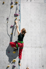 girl climbing up the wall