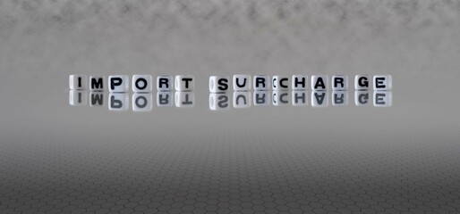 import surcharge word or concept represented by black and white letter cubes on a grey horizon...